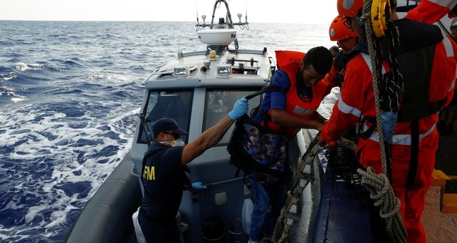 Libya coastguards 'threaten' migrant rescue ship