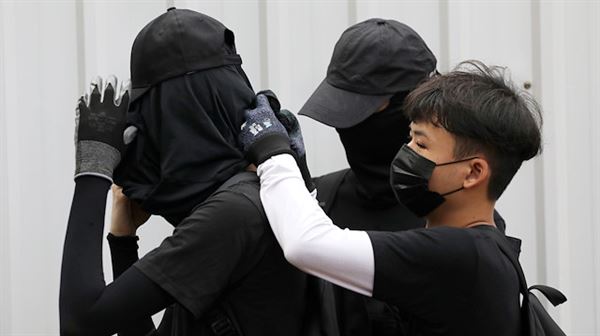 China stops couriers from shipping black clothing to Hong Kong amid…