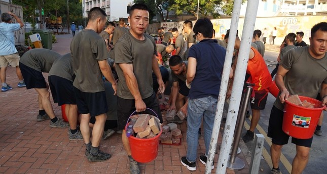 Chinese soldiers join Hong Kong cleanup as protesters retreat