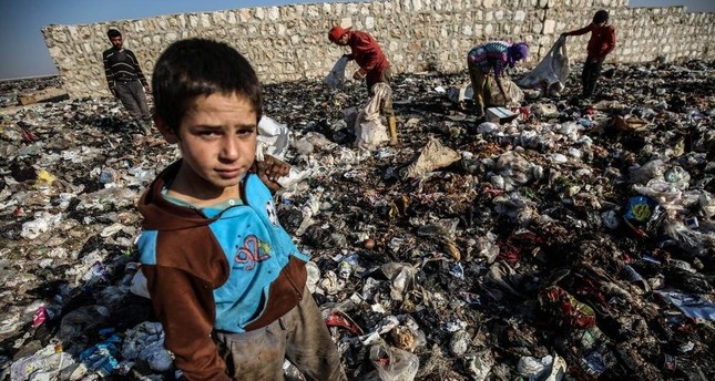 Syrian children in war-torn Idlib scrape out living in garbage dumps