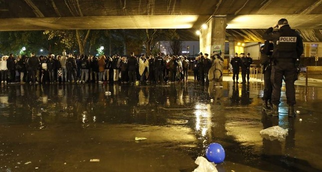 France removes Paris tent camp, pushes tough asylum policies