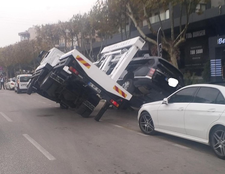 Bursa'da milyonluk aracı kaldırmaya çalışan çekici​ yan yattı