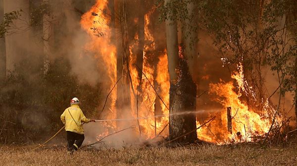 Chopper crashes as Australia battles massive bushfires
