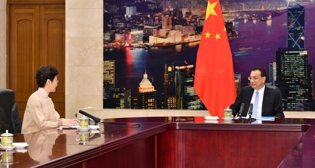 China vows 'unwavering support' for embattled HK leader