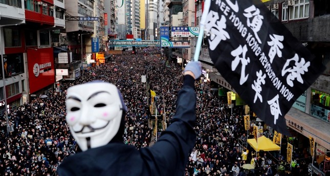 Thousands of protesters mark half year protest anniversary in Hong Kong as government urges calm